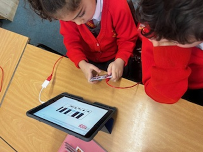 Two children experimenting with musical notes